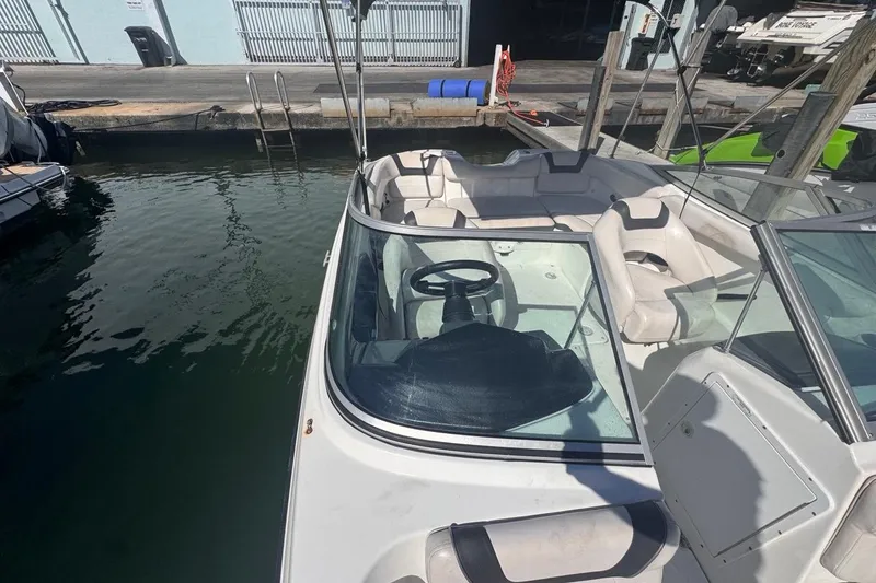 Slide: The Image of 2012 Yamaha Boats SX190 docked, showcasing interior seating and steering wheel. - 32