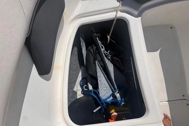 Slide: The Image of Storage compartment of a 2012 Yamaha SX190 boat with anchor and ropes. - 33