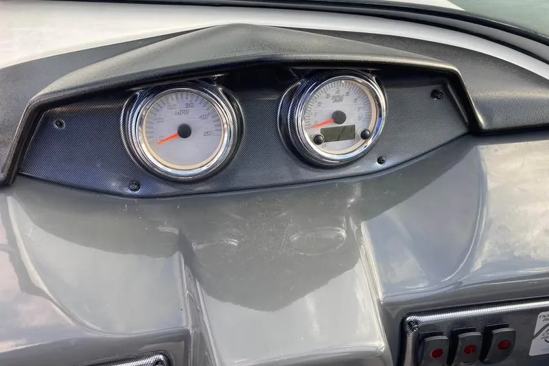 Slide: The Image of 2012 Yamaha Boats SX190 docked in sunny marina with other vessels. - 4