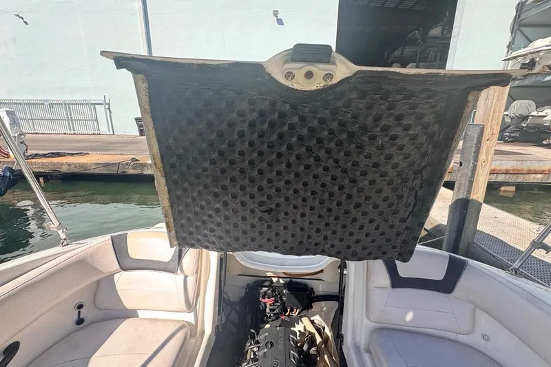 Slide: The Image of 2012 Yamaha SX190 boat engine compartment open, dockside view. - 40