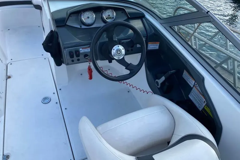 Slide: The Image of 2012 Yamaha Boats SX190 docked, featuring spacious seating and sleek design. - 5