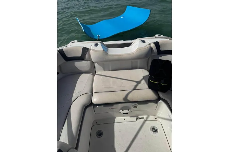 Slide: The Image of 2012 Yamaha Boats SX190, white interior, docked in marina, showcasing seating and controls. - 9