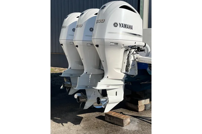 Slide: The Image of Triple Yamaha outboard engines on a 2020 Jupiter 34 Center Console boat. - 10