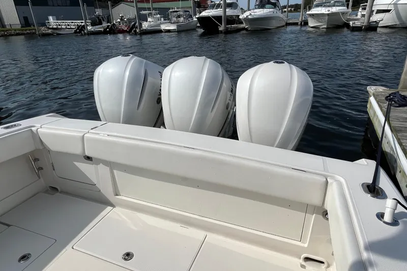 Slide: The Image of 2020 Jupiter 34 Center Console with triple outboard engines docked at marina. - 11