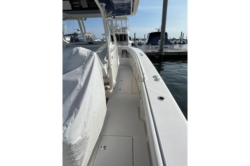 Slide: The Image of 2020 Jupiter 34 Center Console boat docked at marina, side view. - 12
