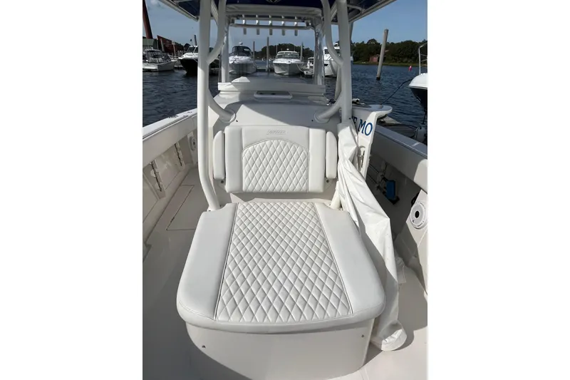 Slide: The Image of 2020 Jupiter 34 Center Console boat with white quilted seating, docked at marina. - 13