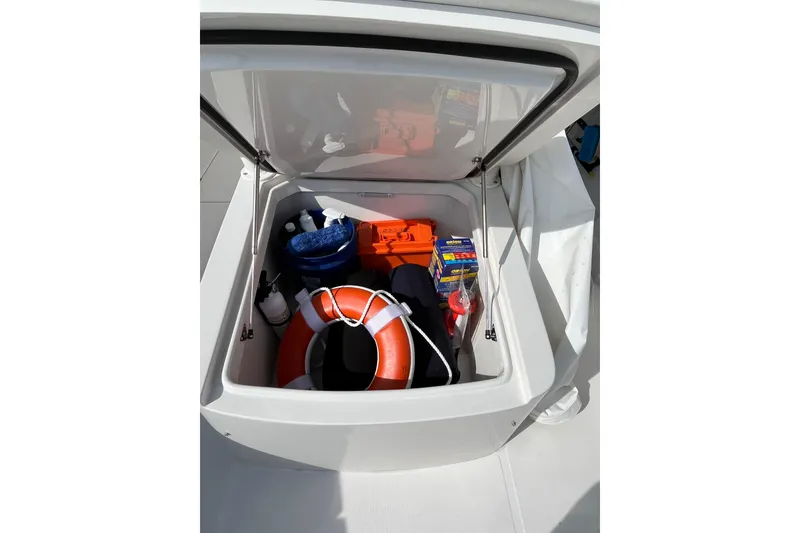 Slide: The Image of Storage compartment on 2020 Jupiter 34 Center Console with safety gear and supplies. - 14