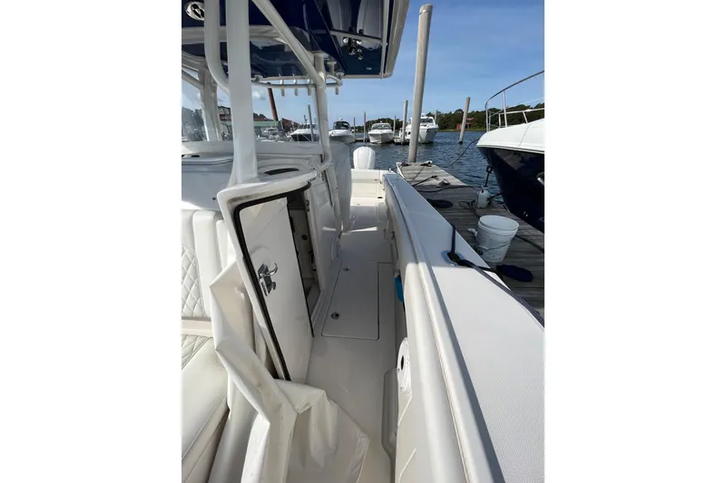 Slide: The Image of 2020 Jupiter 34 Center Console boat docked, showcasing sleek interior and storage compartments. - 20