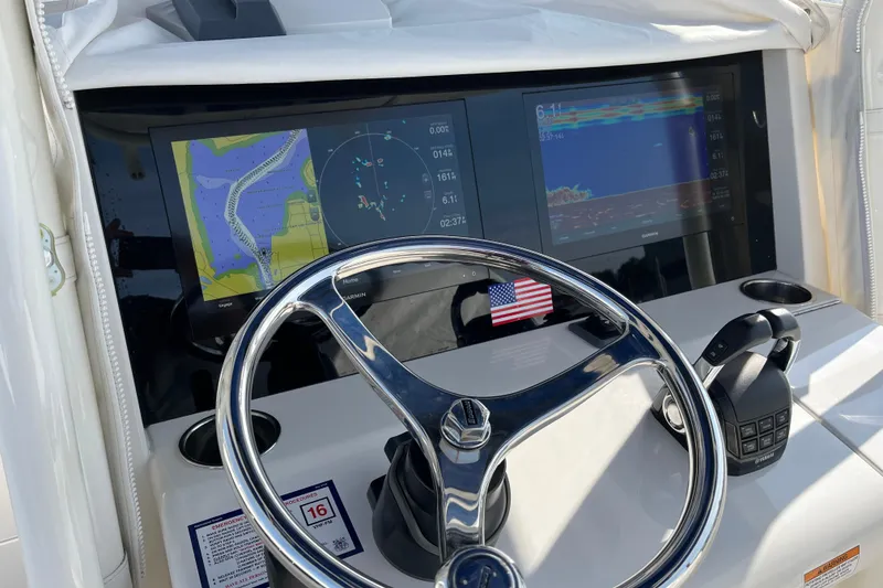 Slide: The Image of Steering console of 2020 Jupiter 34 Center Console with navigation screens and controls. - 24