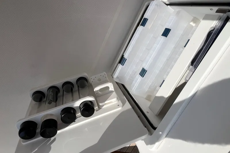 Slide: The Image of Storage compartment on 2020 Jupiter 34 Center Console boat with organized containers. - 32