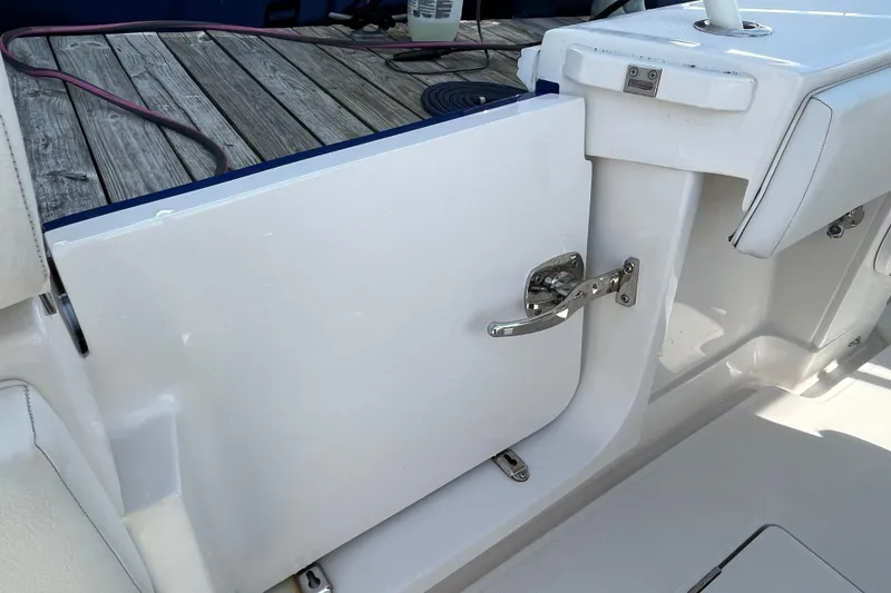 Slide: The Image of 2020 Jupiter 34 Center Console boat with open side door and wooden deck. - 33