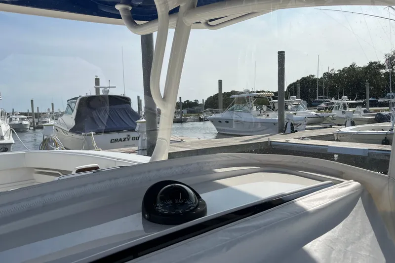 Slide: The Image of 2020 Jupiter 34 Center Console at marina, surrounded by boats. - 41
