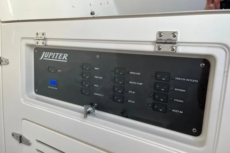 Slide: The Image of Control panel of a 2020 Jupiter 34 Center Console boat with various switches. - 42