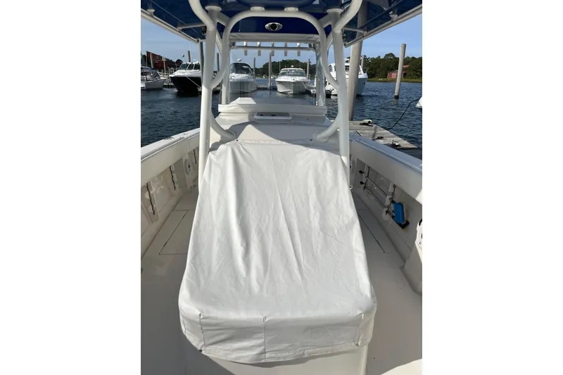 Slide: The Image of 2020 Jupiter 34 Center Console boat docked, featuring covered seating and sleek design. - 48