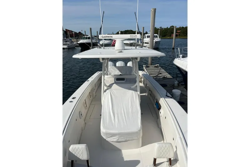 Slide: The Image of 2020 Jupiter 34 Center Console boat docked, featuring a sleek design and spacious deck. - 50