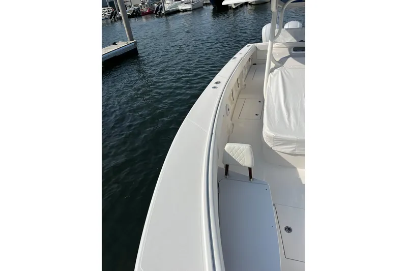Slide: The Image of 2020 Jupiter 34 Center Console boat docked, showcasing sleek design and spacious deck. - 52