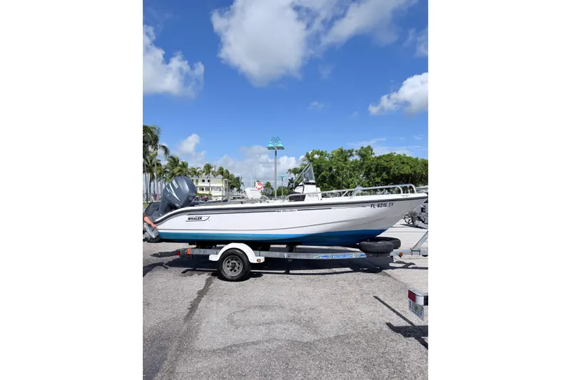 Slide: The Image of 2003 Boston Whaler 180 Dauntless boat on trailer under clear blue sky. - 3