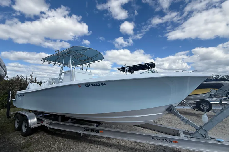 Slide: The Image of 2024 Contender 28 Tournament boat on trailer under blue sky. - 1
