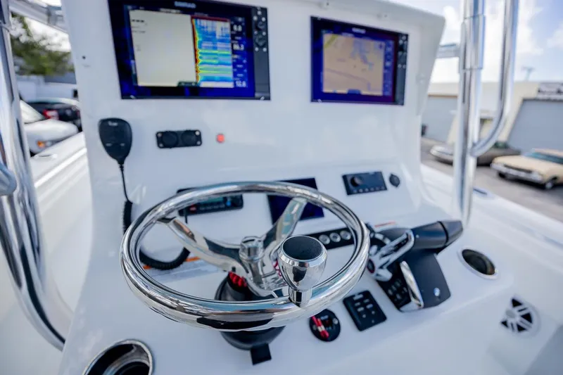 Slide: The Image of 2024 Contender 28 Tournament boat dashboard with advanced navigation systems and controls. - 15