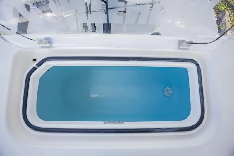 Slide: The Image of Livewell on 2024 Contender 28 Tournament boat, open lid, blue interior. - 18