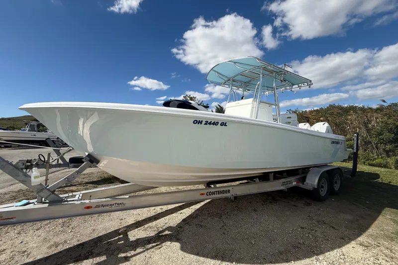 Slide: The Image of 2024 Contender 28 Tournament boat on trailer under blue sky. - 20