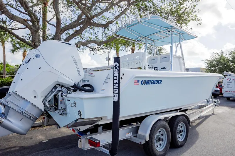 Slide: The Image of 2024 Contender 28 Tournament boat on trailer, featuring Mercury outboard engine. - 22