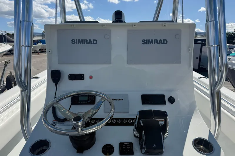 Slide: The Image of 2024 Contender 28 Tournament boat console with dual Simrad displays and Mercury controls. - 23