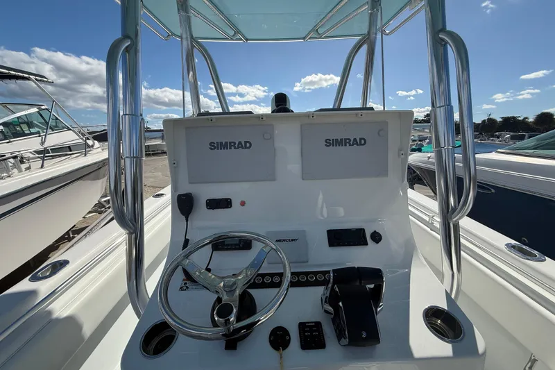 Slide: The Image of 2024 Contender 28 Tournament boat console with Simrad electronics and Mercury controls. - 25