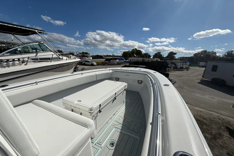 Slide: The Image of 2024 Contender 28 Tournament boat with spacious deck and seating under a clear blue sky. - 26