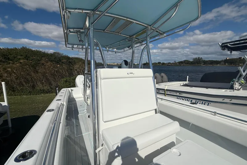 Slide: The Image of 2024 Contender 28 Tournament boat with sleek design, docked by a scenic waterfront. - 28