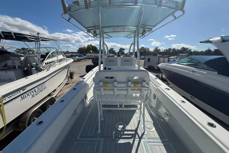 Slide: The Image of 2024 Contender 28 Tournament boat interior with seating and equipment, docked alongside other boats. - 3