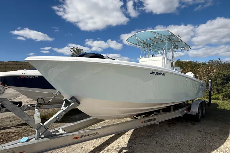 Slide: The Image of 2024 Contender 28 Tournament boat on trailer under blue sky. - 34