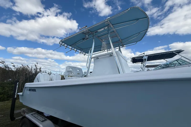 Slide: The Image of 2024 Contender 28 Tournament boat with blue canopy under a cloudy sky. - 35