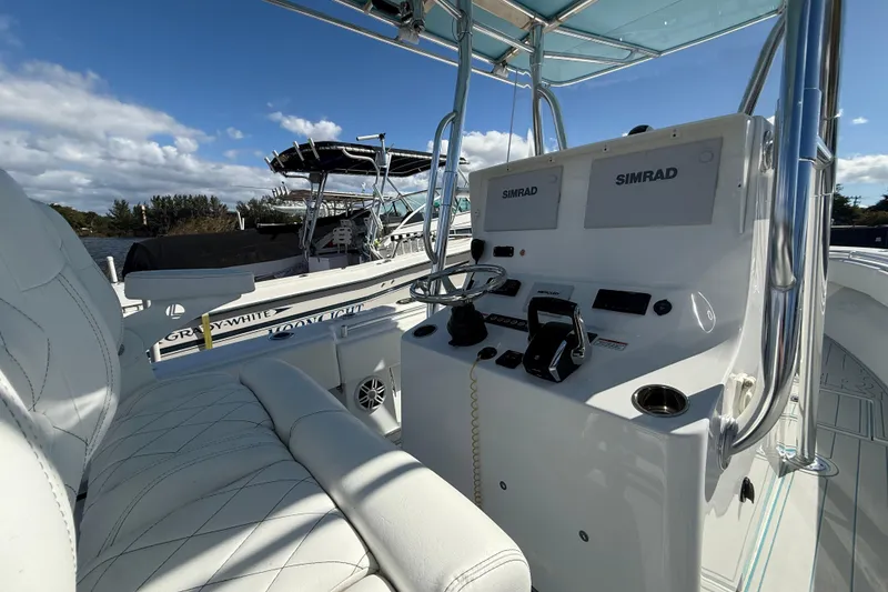 Slide: The Image of 2024 Contender 28 Tournament boat interior with Simrad electronics and white seating. - 4