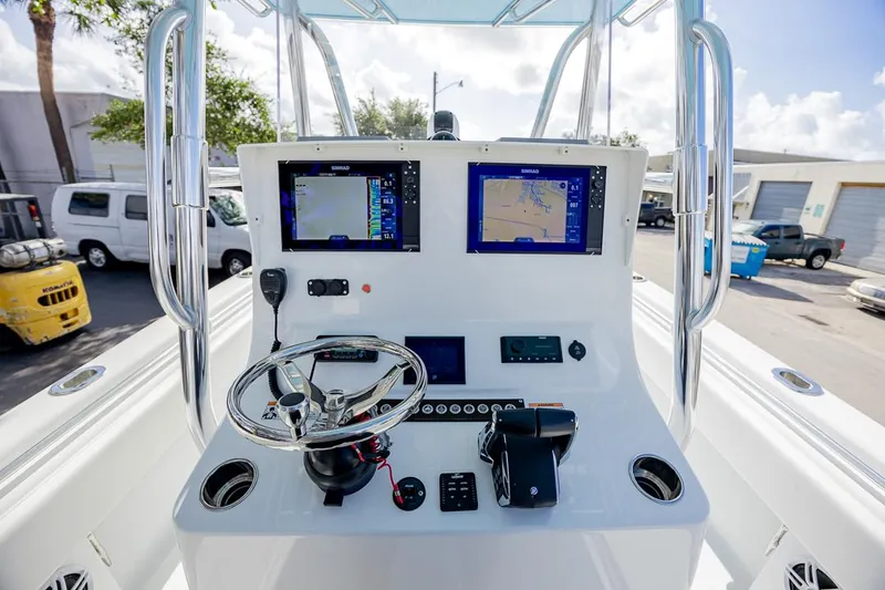 Slide: The Image of 2024 Contender 28 Tournament boat dashboard with dual navigation screens and steering wheel. - 5