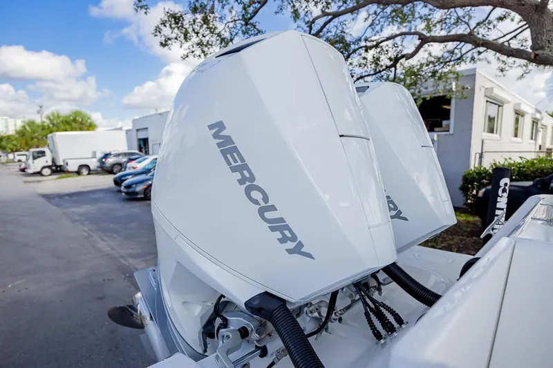 Slide: The Image of 2024 Contender 28 Tournament with dual Mercury outboard engines, parked outdoors. - 6