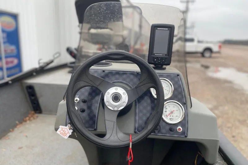 Slide: The Image of 2018 Tracker Pro 160 boat dashboard with steering wheel and gauges. - 6