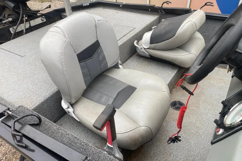 Slide: The Image of 2018 Tracker Pro 160 boat interior with gray seats and steering wheel. - 7