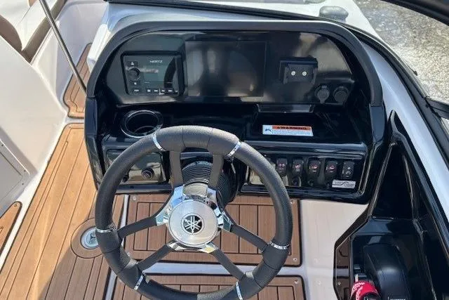 Slide: The Image of 2023 Yamaha Boats 195S dashboard with steering wheel and control panel. - 16