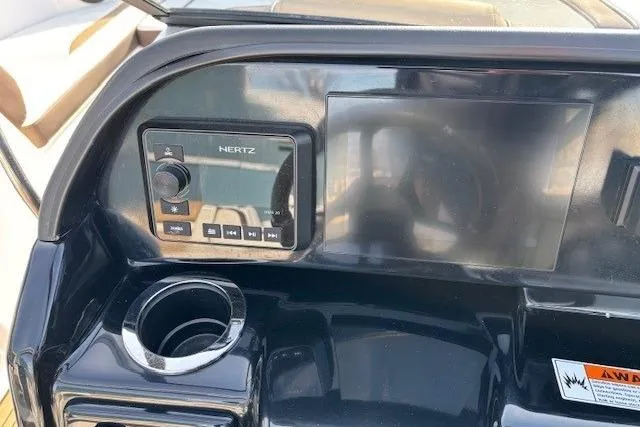 Slide: The Image of Dashboard of 2023 Yamaha Boats 195S with Hertz audio system and cup holder. - 17