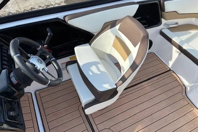 Slide: The Image of 2023 Yamaha Boats 195S interior with sleek seating and modern steering wheel design. - 19