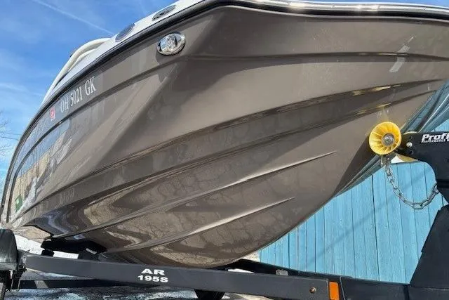 Slide: The Image of 2023 Yamaha Boats 195S on trailer, close-up view of hull and bow. - 2