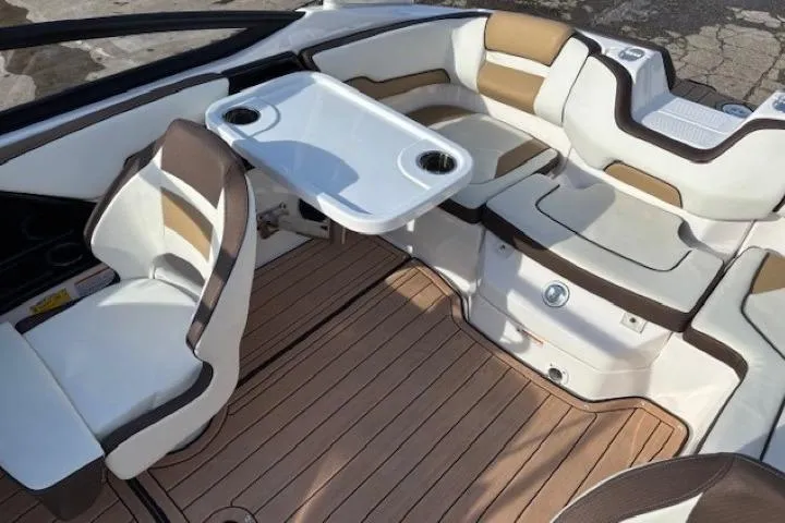 Slide: The Image of 2023 Yamaha Boats 195S interior with seating and table, featuring elegant design and wood-like flooring. - 22
