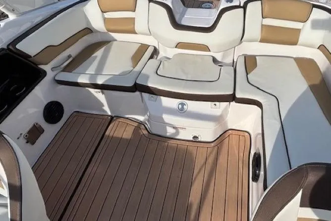 Slide: The Image of 2023 Yamaha Boats 195S interior with cushioned seating and wood-style flooring. - 23