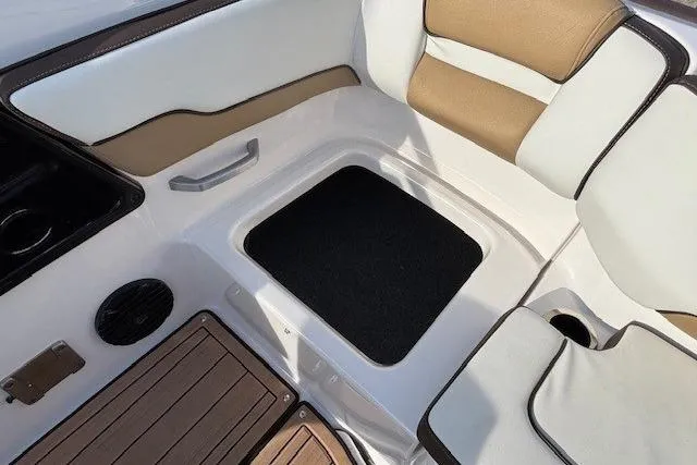 Slide: The Image of 2023 Yamaha Boats 195S interior seating with storage compartment and cup holder. - 25