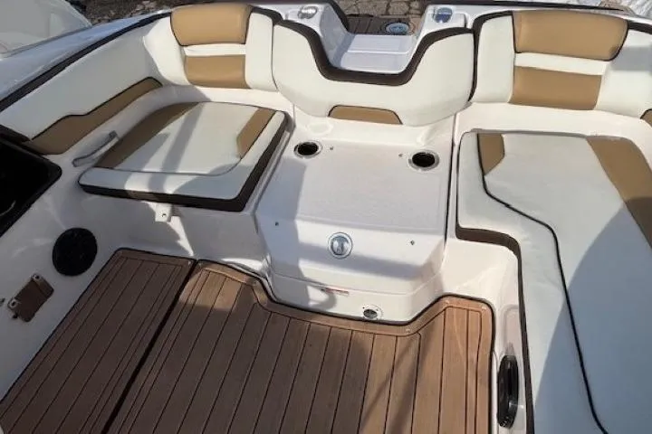 Slide: The Image of 2023 Yamaha Boats 195S interior with cushioned seating and wood-style flooring. - 26