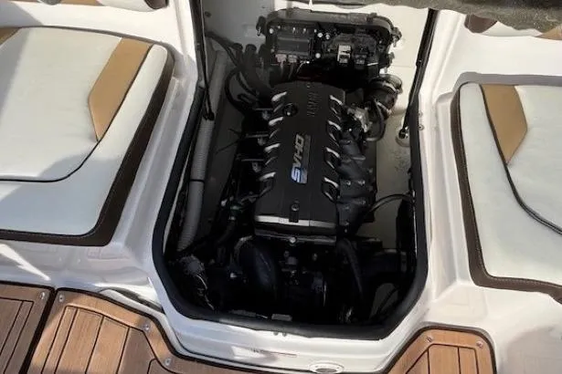 Slide: The Image of 2023 Yamaha Boats 195S engine compartment with seating and wooden deck. - 28