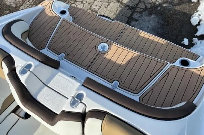 Slide: The Image of 2023 Yamaha Boats 195S swim platform with teak-style decking and cushioned seating. - 29