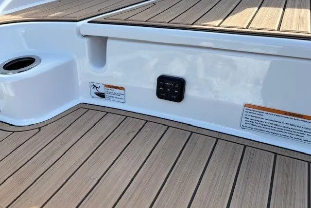 Slide: The Image of 2023 Yamaha Boats 195S deck with wood finish and control panel. - 31