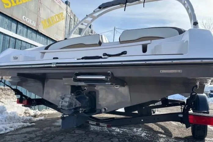 Slide: The Image of 2023 Yamaha Boats 195S on trailer, rear view, in snowy outdoor setting. - 5